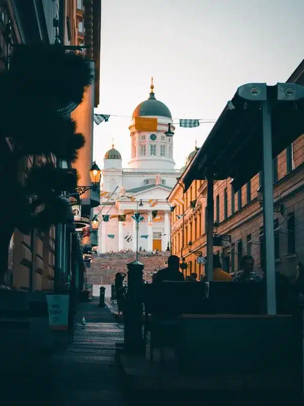 Cathedral in background of people sitting at cafe